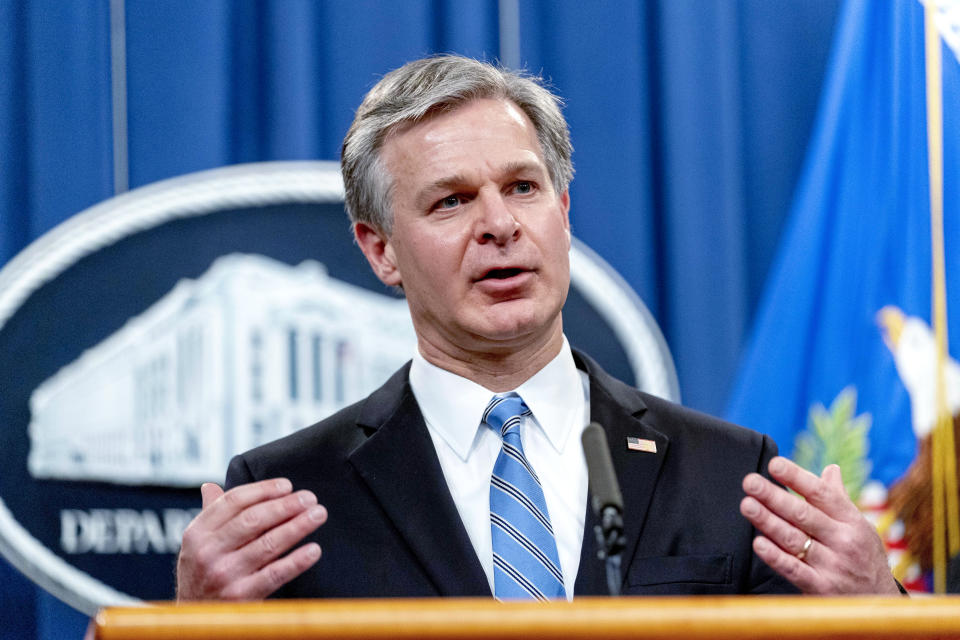 FILE - FBI Director Christopher Wray speaks at a news conference at the Justice Department in Washington Nov. 8, 2021. Companies critical to U.S. national interests will have to report when they’re hacked or they pay ransomware. The new rules approved by Congress are part of a broader effort by the Biden administration and Congress to shore up the nation’s cyberdefenses after a series of high-profile digital espionage campaigns and disruptive ransomware attacks. (AP Photo/Andrew Harnik, File)
