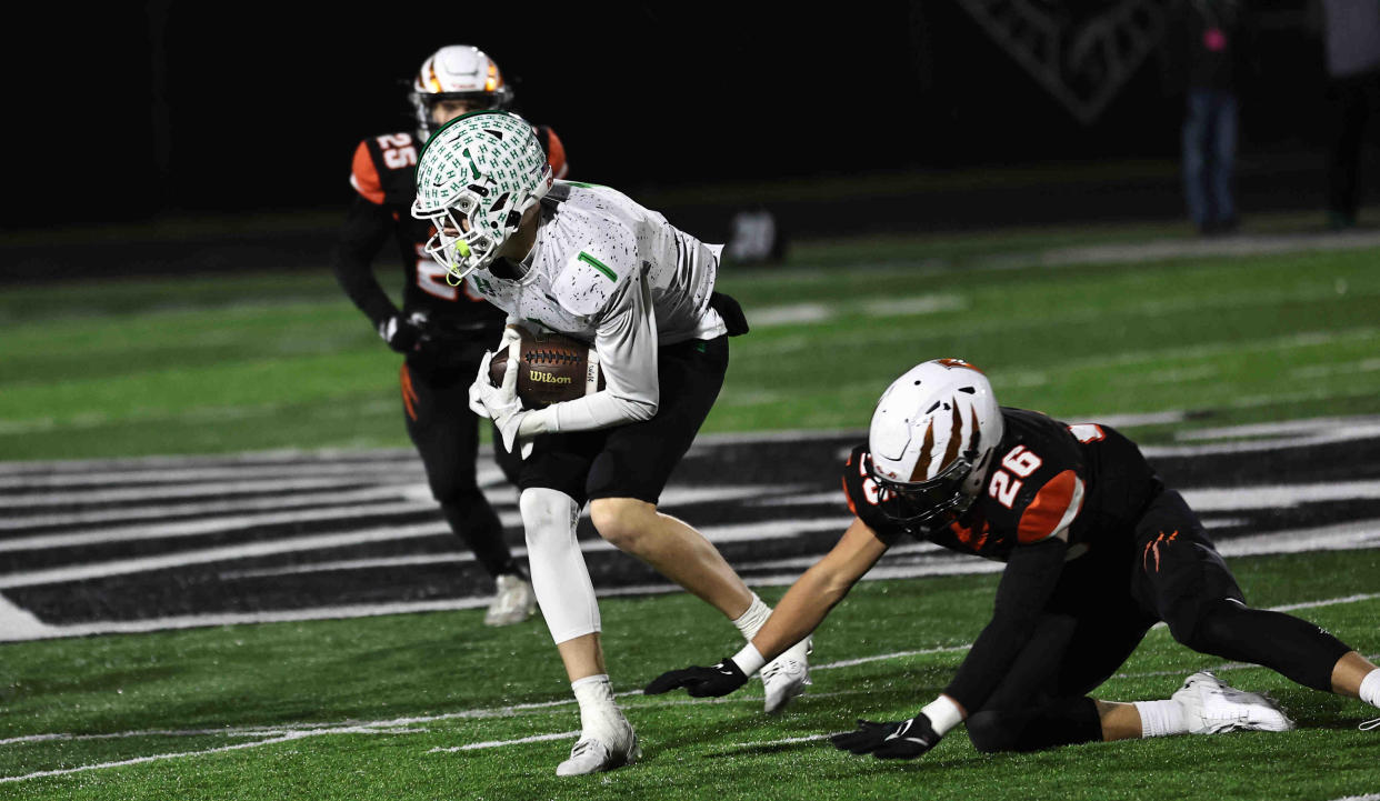 Harrison wide receiver Luke Rogers, catching a pass against Anderson in November 2023, will sign to play football for Mount St. Joseph University.