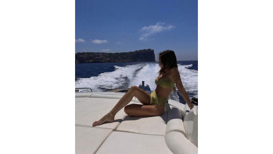 Michelle Keegan in a green bikini on a boat