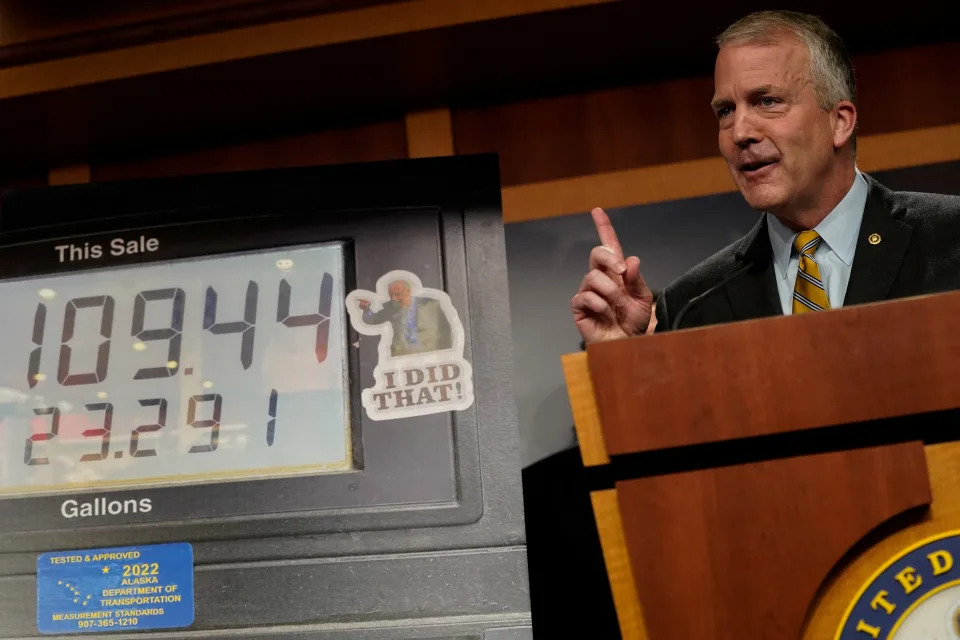 U.S. Senator Dan Sullivan (R-AK) speaks in front of a photo of a gas pump display featuring a sticker of U.S. President Joe Biden, during a press conference about high gas prices for consumers at the U.S. Capitol in Washington, U.S., April 6, 2022. REUTERS/Elizabeth Frantz