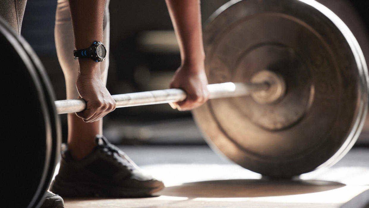  Detail of woman lifting weights. 