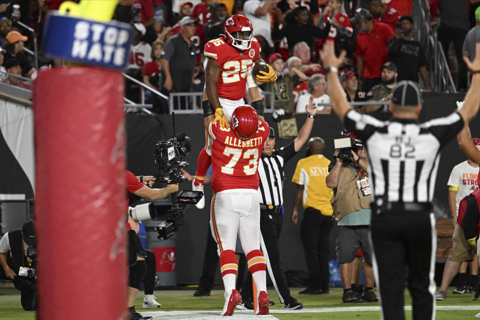 Kansas City Chiefs running back Clyde Edwards-Helaire (25) celebrates a touchdown with guard Nick Allegretti (73) as during the first half of an NFL football game against the Tampa Bay Buccaneers Sunday, Oct. 2, 2022, in Tampa, Fla. (AP Photo/Jason Behnken)