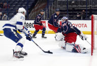 Tampa Bay Lightning defenseman Ryan McDonagh, left, shoots and scores against Columbus Blue Jackets goalie Elvis Merzlikins, right, during the first period an NHL hockey game in Columbus, Ohio, Thursday, April 8, 2021. (AP Photo/Paul Vernon)