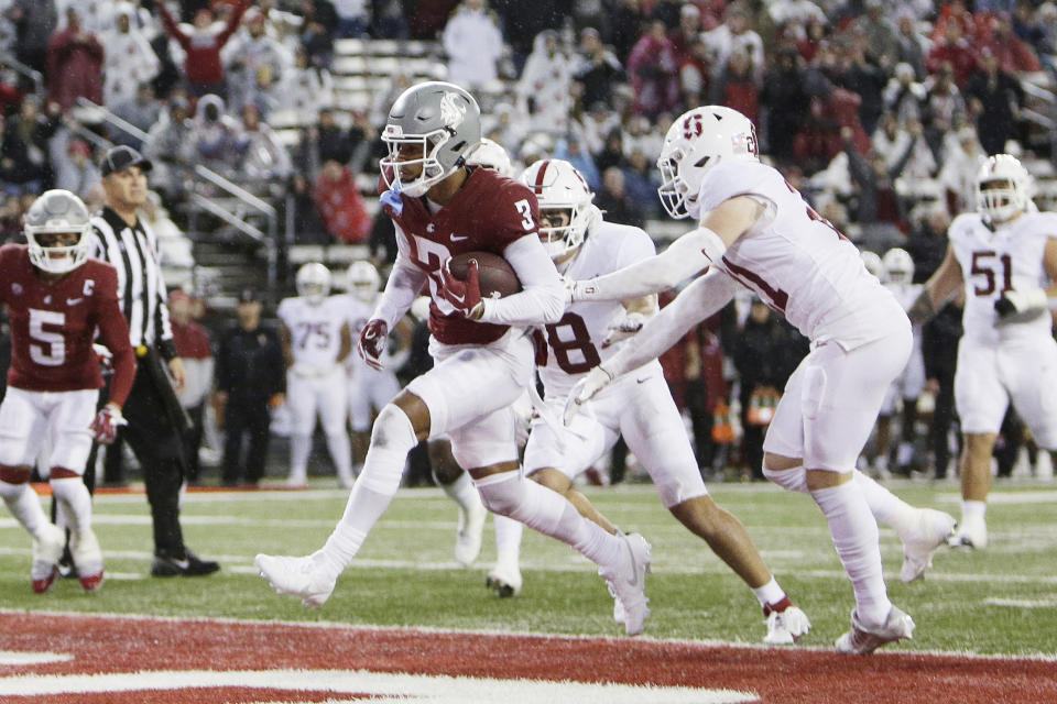 Washington State wide receiver Josh Kelly (3) runs for a touchdown while pressured by Stanford safety Scotty Edwards during the first half of an NCAA college football game Saturday, Nov. 4, 2023, in Pullman, Wash. (AP Photo/Young Kwak)