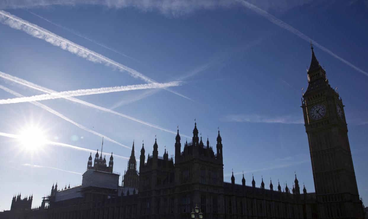 Contrails or vapour trails made by passing aircraft in the sky above the Houses of Parliament: AFP/Getty Images