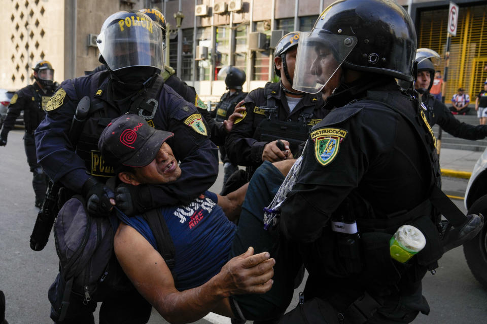 Police detain a protester marching against President Dina Boluarte in Lima, Peru, Thursday, Jan. 19, 2023. Protesters are seeking immediate elections, the resignation of Boluarte, the release from prison of ousted President Pedro Castillo and justice for protesters killed in clashes with police. (AP Photo/Martin Mejia)