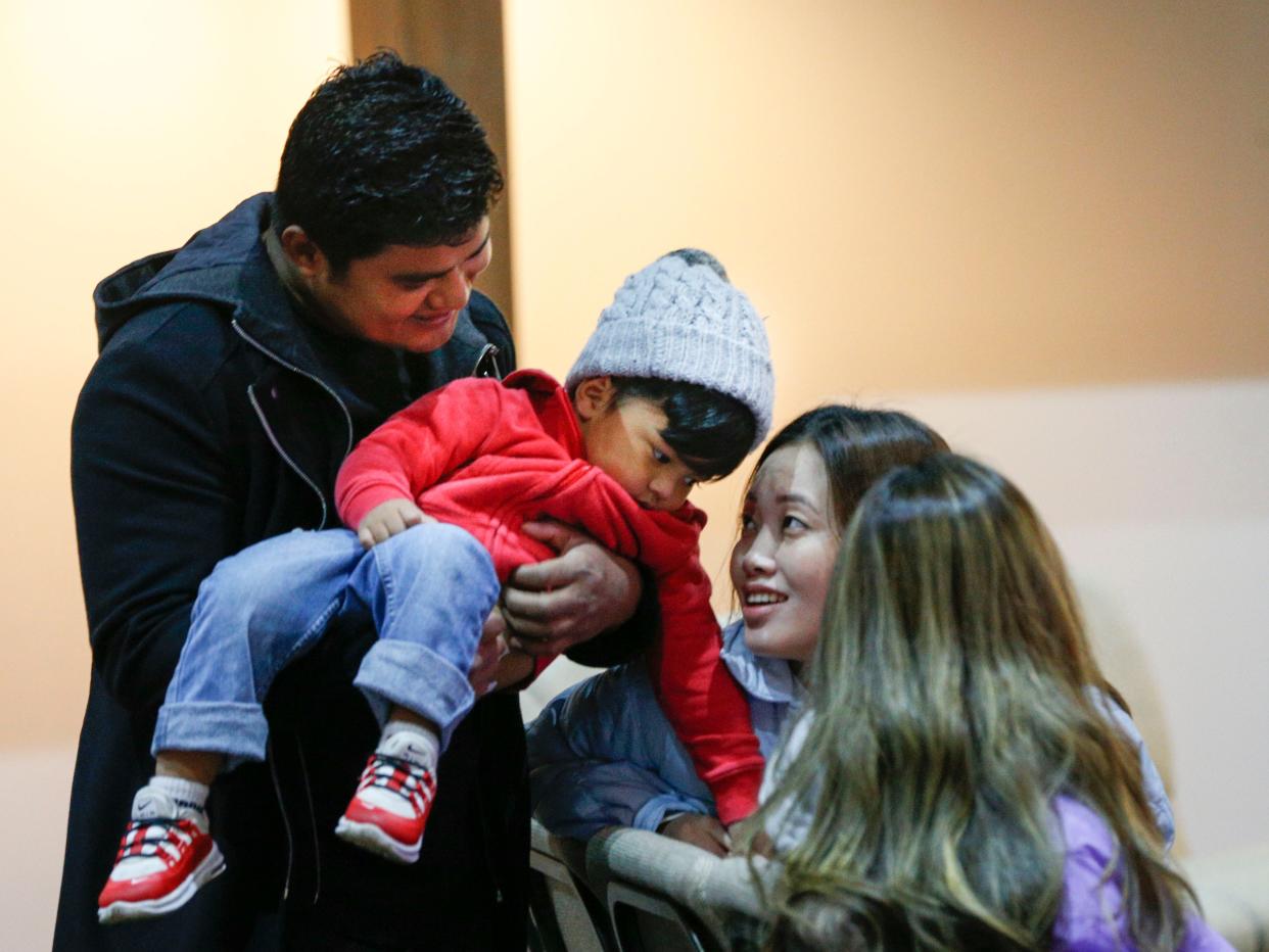Pastor Mishael Bhujel, left, who created Home Church to minister to people from Bhutan and Nepal, shares a moment with his nephew Eden, 2, before he leads a service at the First Alliance Church building on the Northwest Side.