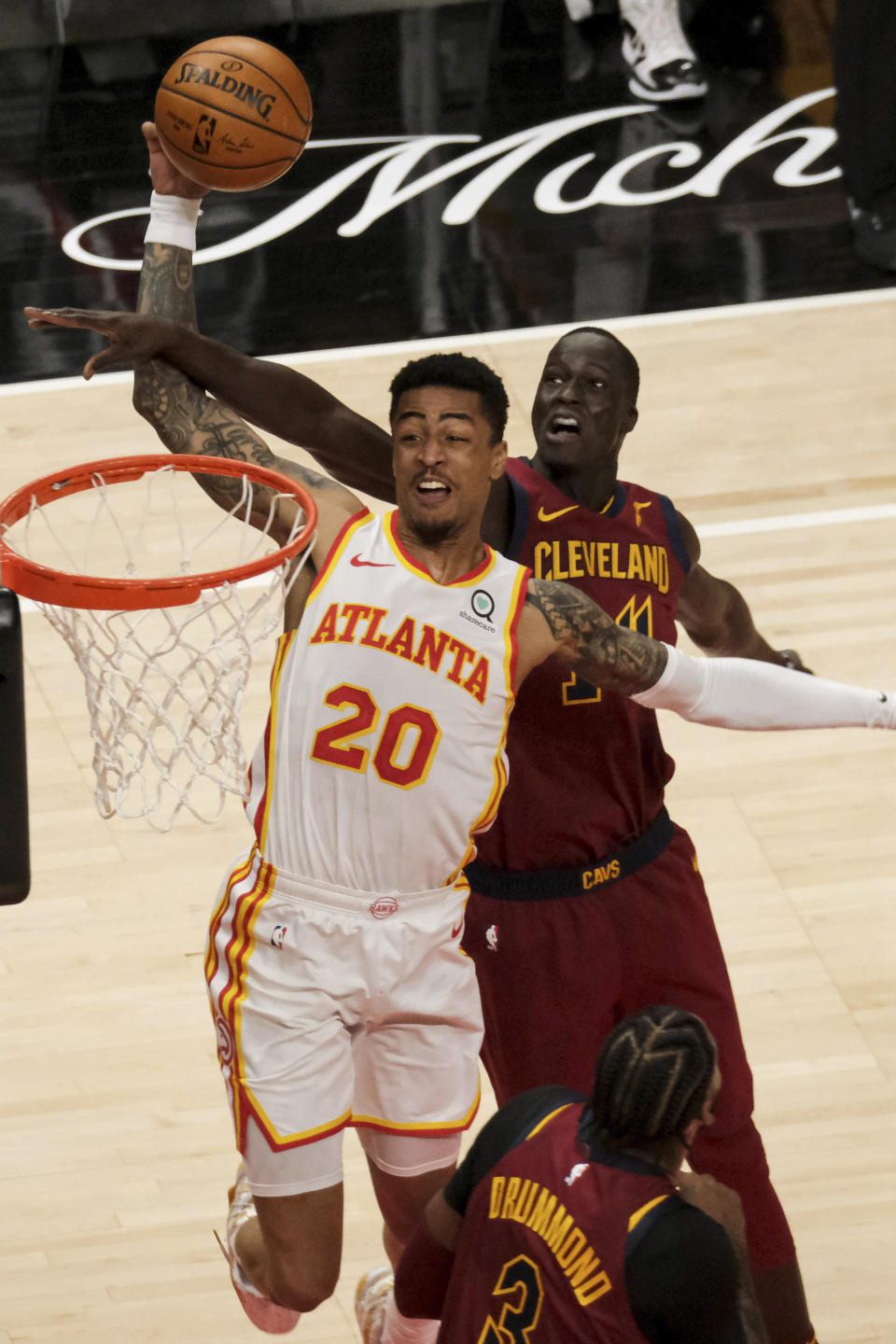 Atlanta Hawks forward John Collins (20) is fouled by Cleveland Cavaliers center Thon Maker (14) during the first half of an NBA basketball game on Saturday, Jan. 2, 2021 in Atlanta. (AP Photo/Ben Gray)