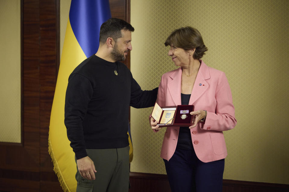 In this photo provided by the Ukrainian Presidential Press Office, French Foreign and European Affairs Minister Catherine Colonna, right, holds Ukrainian state award during her meeting with Ukrainian President Volodymyr Zelenskyy in Kyiv, Ukraine, Monday, Oct. 2, 2023. (Ukrainian Presidential Press Office via AP)