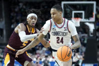 FILE - Connecticut's Jordan Hawkins (24) drives against Iona's Daniss Jenkins (5) in the second half of a first-round college basketball game in the NCAA Tournament, Friday, March 17, 2023, in Albany, N.Y. Hawkins is among the top prospects in next month’s NBA draft. (AP Photo/John Minchillo, File)