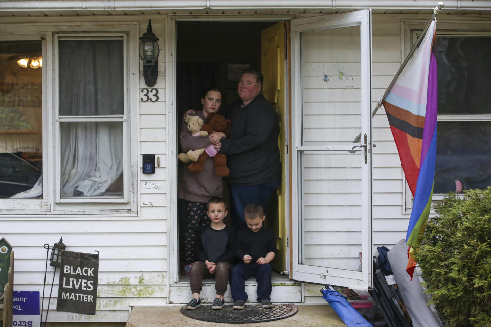 Jillian Philips stands for a potrait with her children Macy, 10, and 4-year old twins, Jude and Emmett, right, at her home, Tuesday, May 2, 2023, in North Brookfield, Mass. Philips, who used the drug Mifepristone to manage her miscarriage, is concerned that other women who miscarry could suffer if the pill, also used for abortions, is taken off the market. (AP Photo/Reba Saldanha)