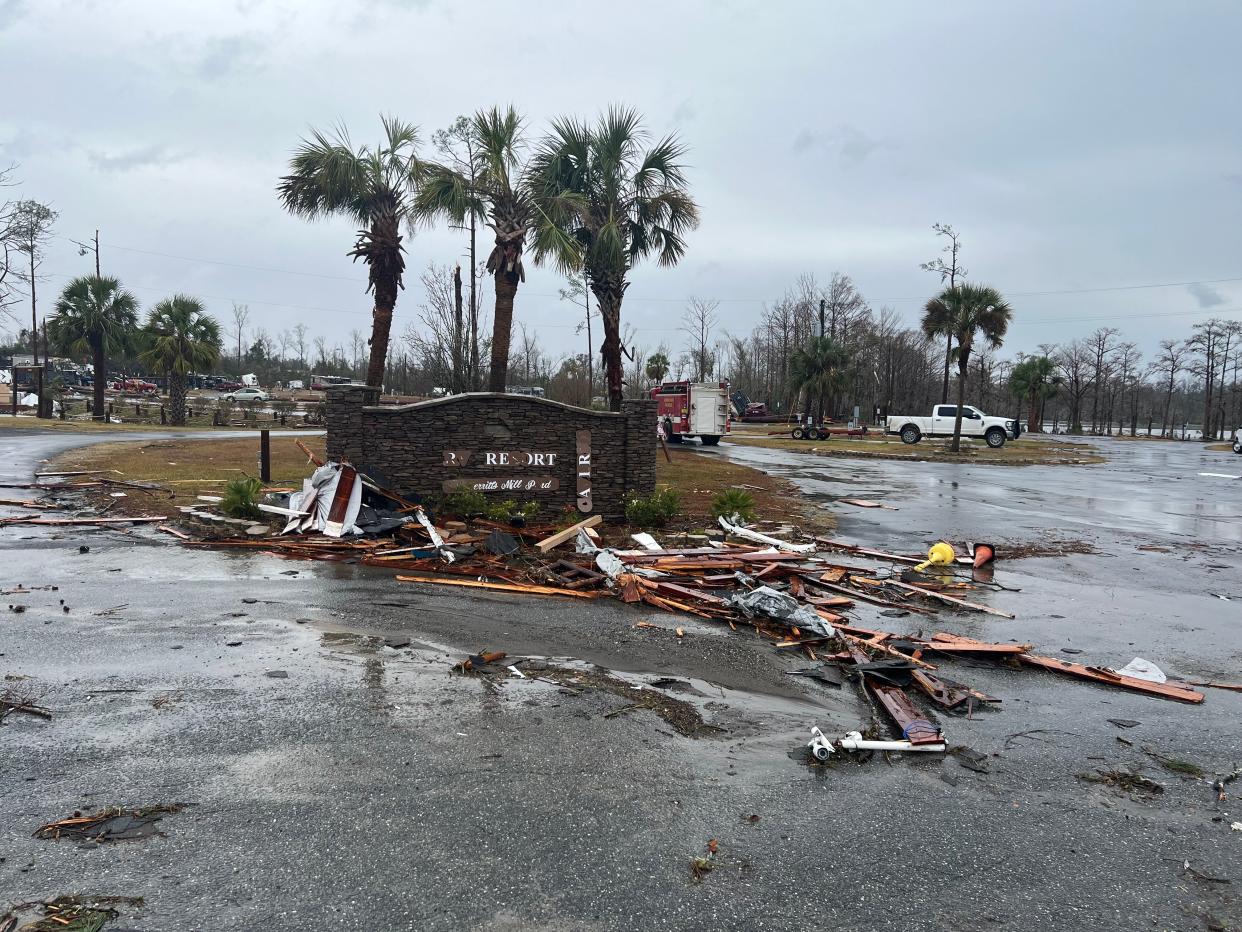 A damaged sign in a parking lot and debris pictured in Jackson County, Florida on 9 January following a tornado (Courtesy of Ramsey Romero)
