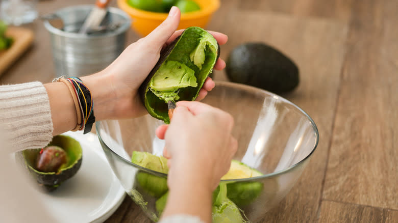 Person making guacamole