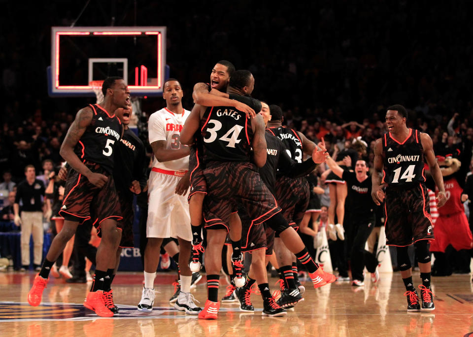 NEW YORK, NY - MARCH 09: Dion Dixon #3 hugs Yancy Gates #34 of the Cincinnati Bearcats as time expires against the Syracuse Orange during the semifinals of the Big East men's basketball tournament at Madison Square Garden on March 9, 2012 in New York City. (Photo by Chris Trotman/Getty Images)