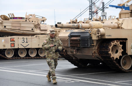 FILE PHOTO: U.S. tanks, trucks and other military equipment, which arrived by ship, are unloaded in the harbour of Bremerhaven, Germany January 8, 2017. REUTERS/Fabian Bimmer/File Photo