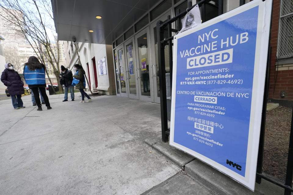 FILE - In this Jan. 21, 2021, file photo, people who had appointments to get COVID-19 vaccinations talk to New York City health care workers outside a closed vaccine hub in the Brooklyn borough of New York after they were told to come back in a week due to a shortage of vaccines. An increasing number of COVID-19 vaccination sites around the U.S. are canceling appointments because of vaccine shortages in a rollout so rife with confusion and unexplained bottlenecks. (AP Photo/Kathy Willens)