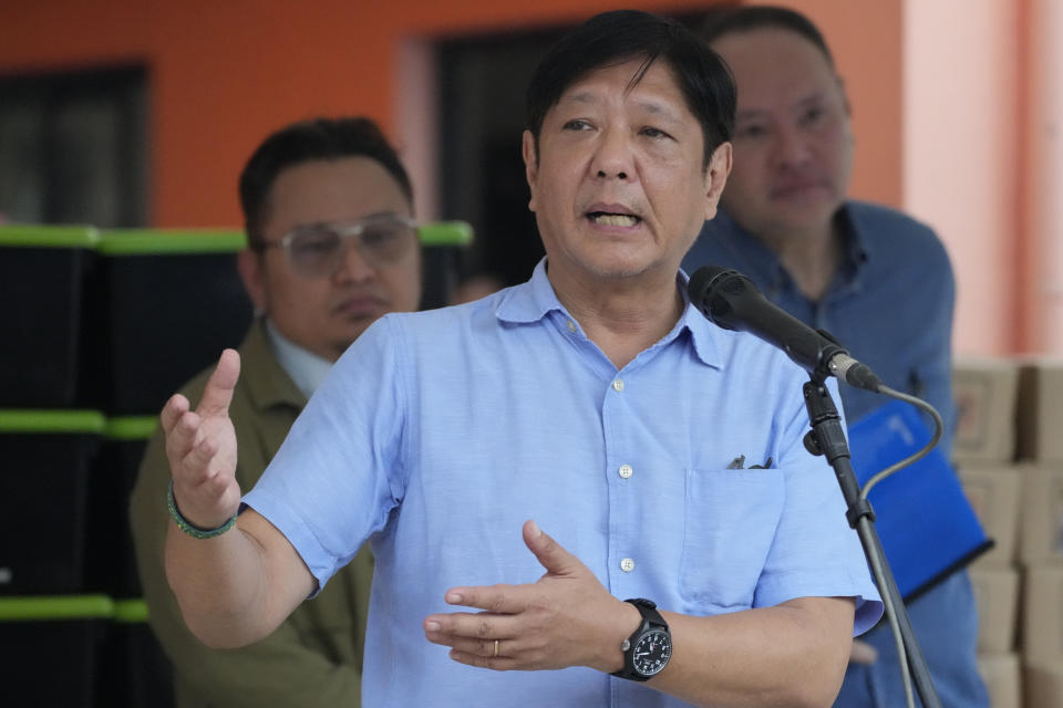Philippine President Ferdinand Marcos Jr. gestures during his speech as he visits an evacuation center in Guinobatan town, Albay province, northeastern Philippines, Wednesday, June 14, 2023. A gentle eruption of the Philippines' most active volcano that has forced nearly 18,000 people to flee to emergency shelters could last for months and create a protracted crisis, officials said Wednesday. (AP Photo/Aaron Favila)