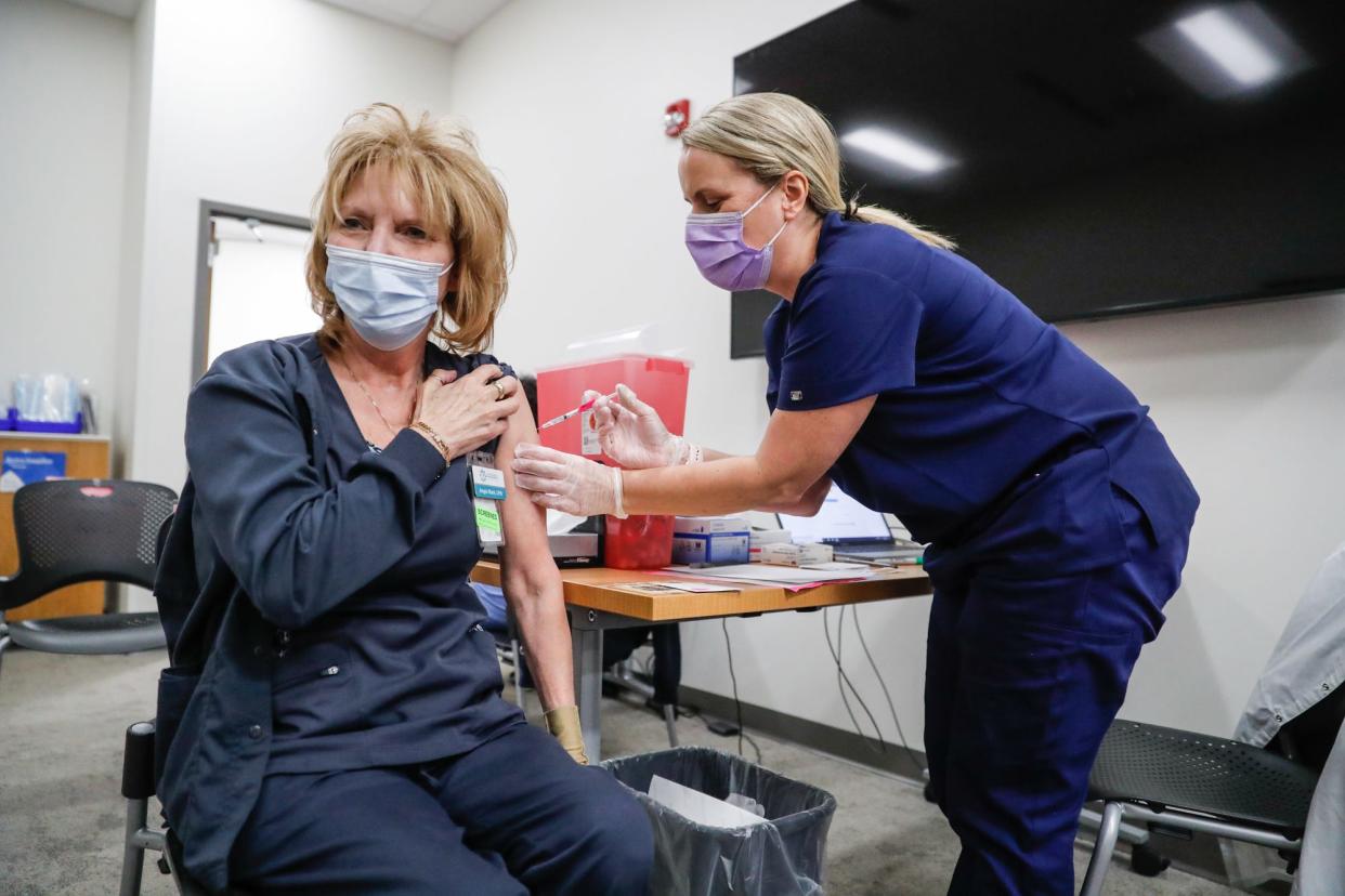 Nursing student Brandi White, right, injects her mother, Angie Stark, left, with the Pfizer vaccine at  Ascension St. Vincent William K. Nasser, MD, Healthcare Education, and Simulation Center: 1801 W. 86th Street, Indianapolis, on Saturday, Jan. 16, 2021. 