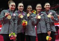 <p>McKayla Maroney, Jordyn Wieber, Gabrielle Douglas, Alexandra Raisman and Kyla Ross of the United States celebrate after winning the gold medal in the Artistic Gymnastics Women’s Team final on Day 4 of the London 2012 Olympic Games at North Greenwich Arena on July 31, 2012 in London, England. (Photo by Ronald Martinez/Getty Images) </p>