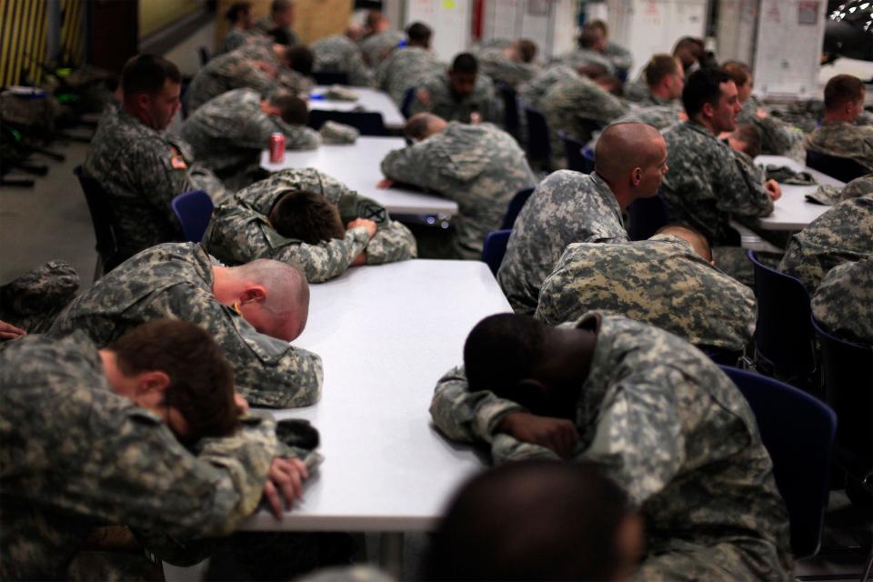 FILE PHOTO: U.S. Army soldiers sleep in their chairs after returning to base during a 24 hour Cavalry 