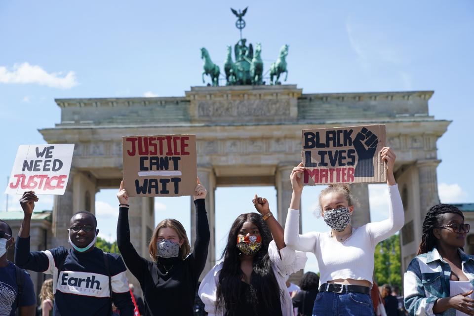 People attend a rally against racism in front of the Brandenburg Gate on May 31 in Berlin after the death of George Floyd in the USA.