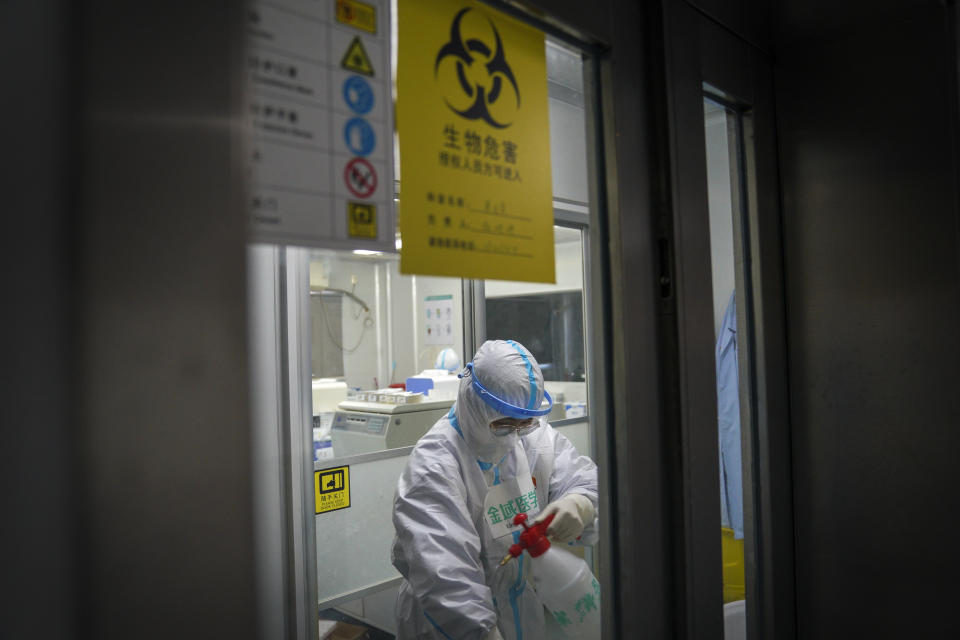 In this photo released by Xinhua News Agency, a medical worker disinfectants herself at a testing lab of KingMed Diagnostics Group Co., Ltd. in Shijiazhuang in northern China's Hebei Province on Saturday, Jan. 9, 2021. Chinese health authorities say scores more people have tested positive for coronavirus in Hebei province bordering on the capital Beijing. The outbreak focused on the Hebei cities of Shijiazhuang and Xingtai is one of China's most serious in recent months and comes amid measures to curb the further spread during next month's Lunar New Year holiday. (Mu Yu/Xinhua via AP)