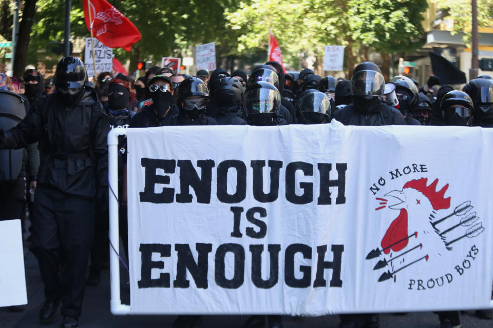 FILE - In this June 29, 2019, file photo, multiple groups, including Rose City Antifa, the Proud Boys and conservative activist Haley Adams protest in downtown Portland, Ore. Portland police are mobilizing in hopes of avoiding clashes between out-of-state hate groups planning a rally Saturday, Aug. 17, 2019, and homegrown anti-fascists who say they’ll come out to oppose them. Since President Donald Trump’s election, Portland has become a political arena for far-right and far-left groups to face off. (Dave Killen/The Oregonian via AP)