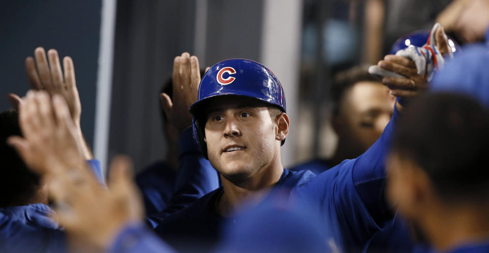 Chicago Cubs' Anthony Rizzo celebrates with with teammates in the dugout after hitting a two-run home run against the Los Angeles Dodgers during the ninth inning of a baseball game in Los Angeles, Saturday, June 15, 2019. The Cubs won 2-1. (AP Photo/Alex Gallardo)