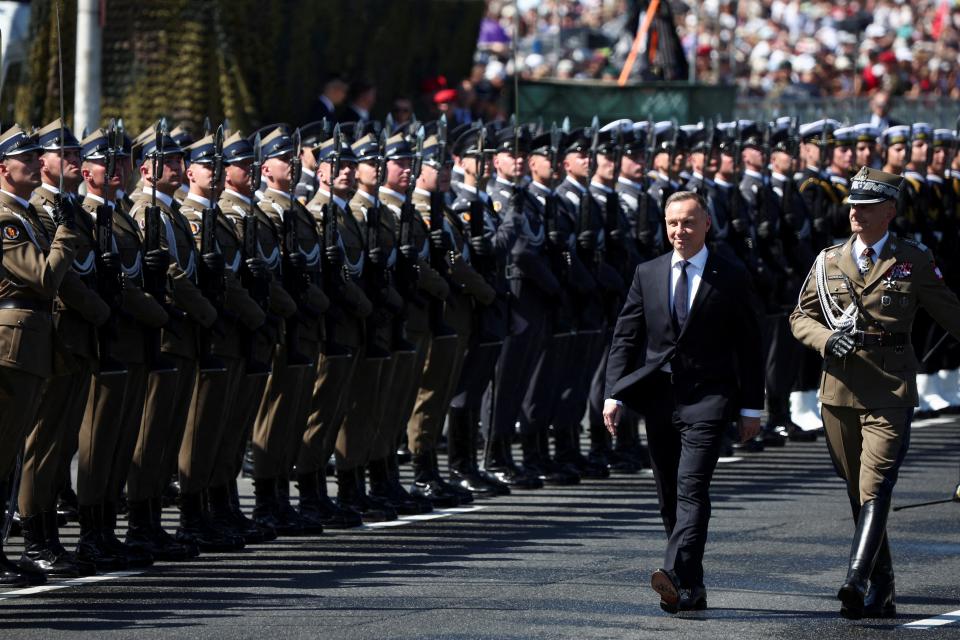 Polish President Andrzej Duda, flanked by Chief of the General Staff of the Polish Armed Forces General Rajmund Andrzejczak, attends the military parade on Armed Forces Day (REUTERS)