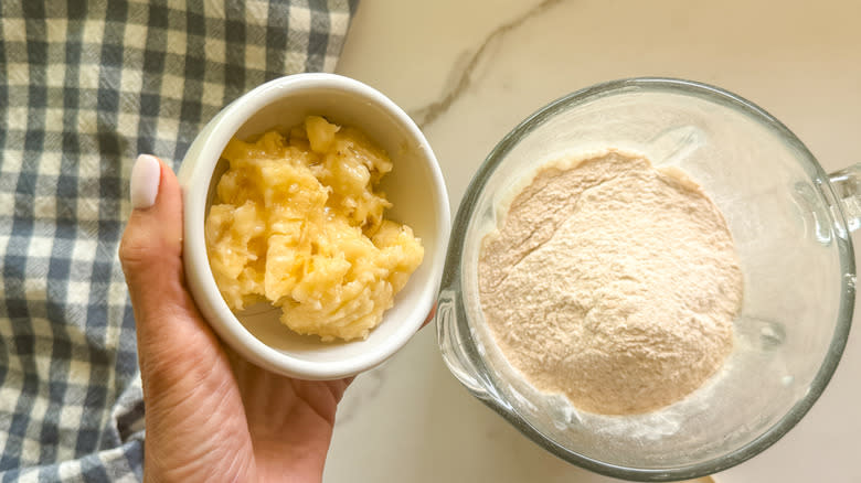 hand adding mashed banana