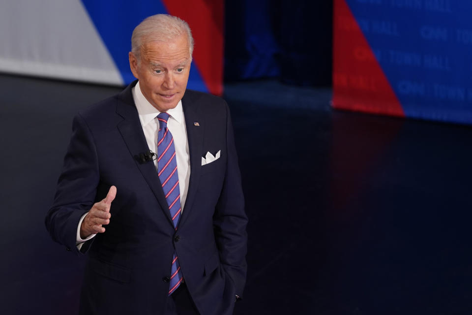 President Joe Biden participates in a CNN town hall at the Baltimore Center Stage Pearlstone Theater, Thursday, Oct. 21, 2021, in Baltimore, with moderator Anderson Cooper. (AP Photo/Evan Vucci)