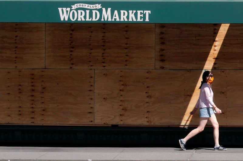 A woman walks outside a Cost Plus World Market, as phase one of reopening after lockdown begins, during the outbreak of the coronavirus disease (COVID-19) in New York