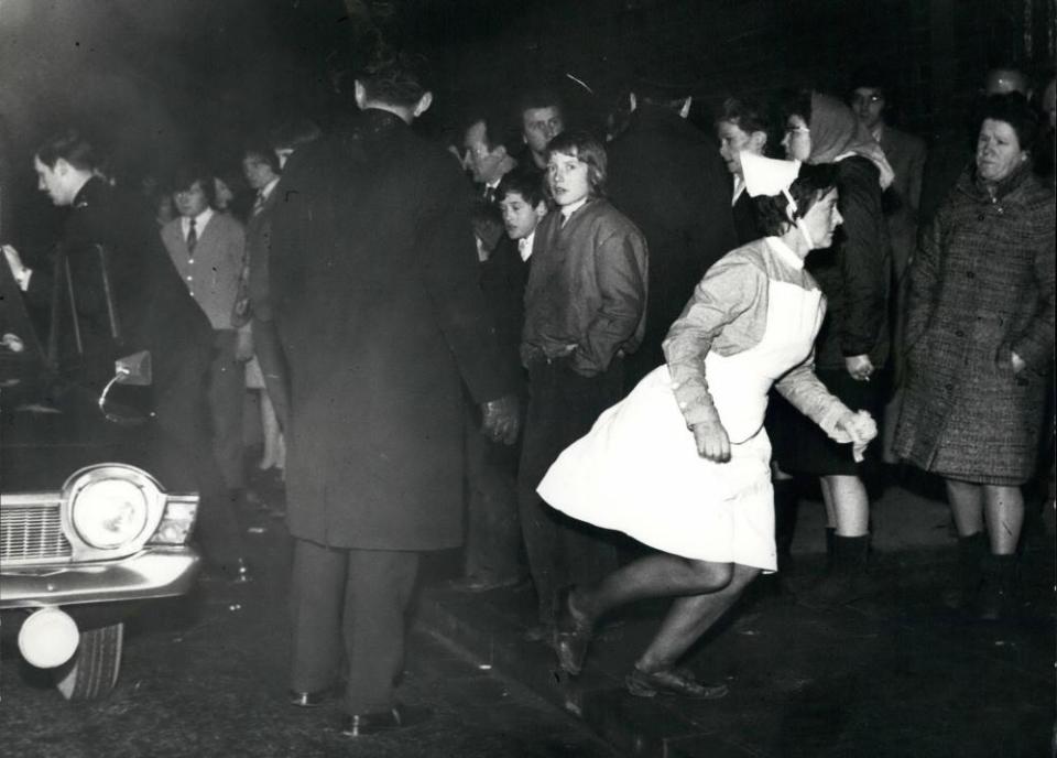 A nurse rushing to help those injured in the Ibrox stadium disaster