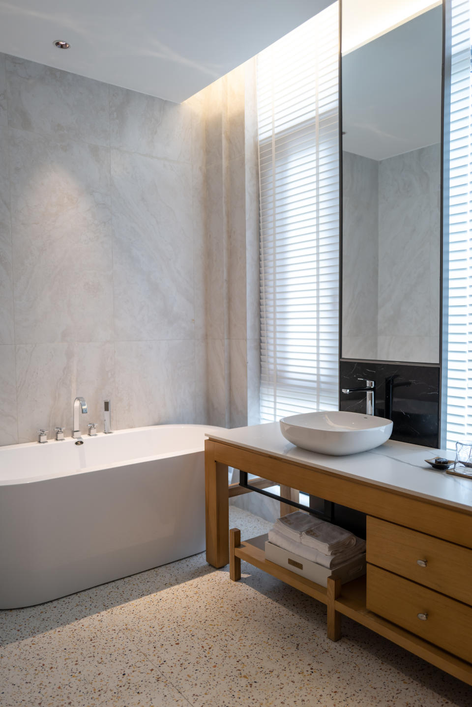 high straight walled bathtub in modern bathroom