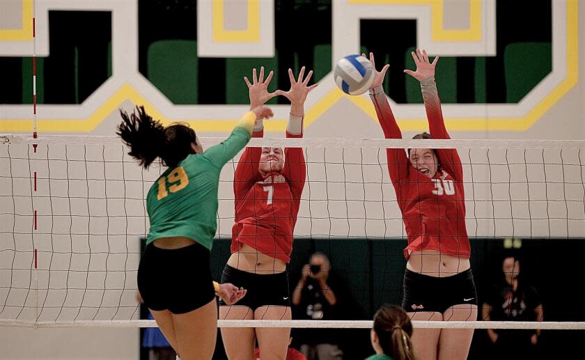 Mira Costa's Simone Roslon is blocked by Mater Dei's Julia Kakkis and Emma Kingston in a nonleague match Aug. 29.