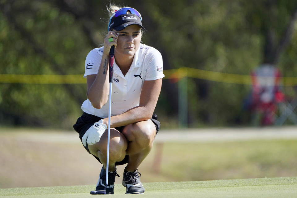 Lexi Thompson looks at her put line on the ninth green during the LPGA The Ascendant golf tournament in The Colony, Texas, Friday, Sept. 30, 2022. (AP Photo/LM Otero)