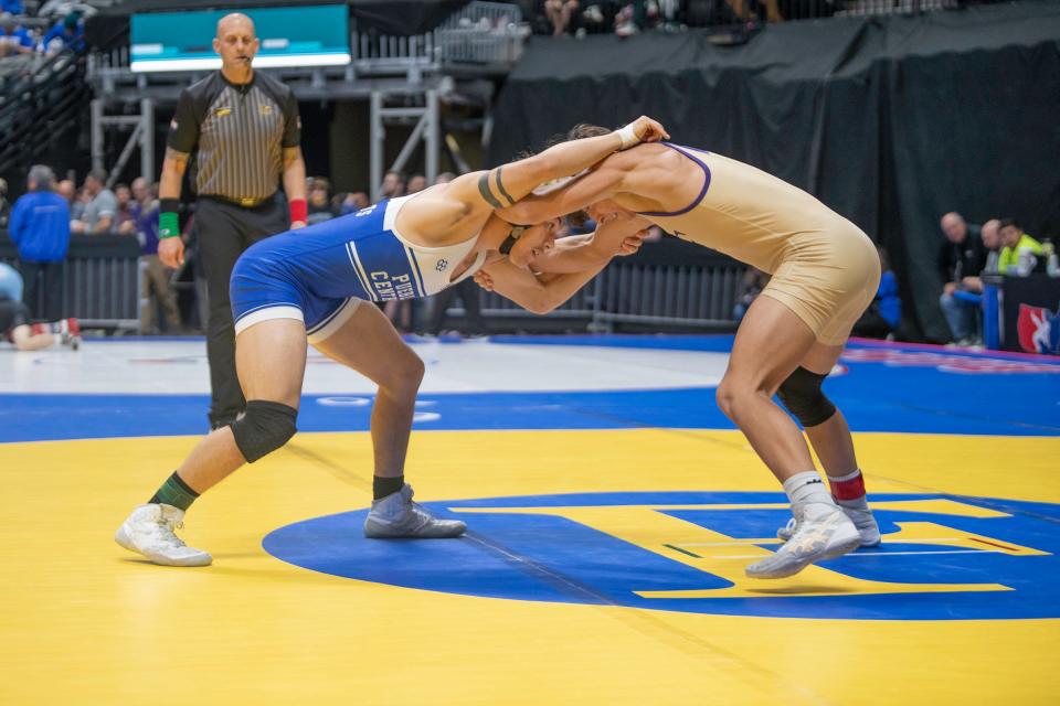 Pueblo Central's Joseph Castro clinches with Holy Family's Brayden Bach during their Class 3A 144-pound first-round matchup of CHSAA state wrestling tournament on Thursday, February, 15, 2024. Castro went on to lose by pinfall.