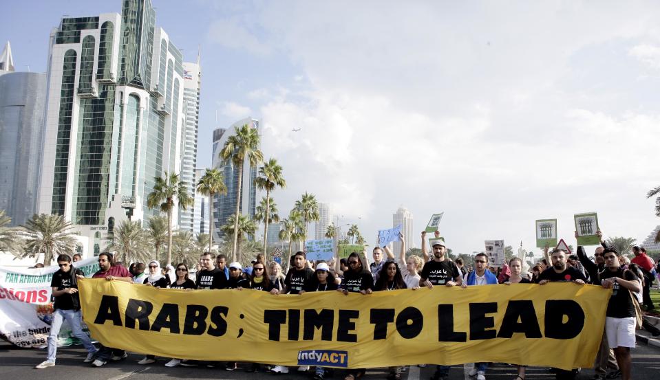 Local and international activists march to demand urgent action to address climate change at the U.N. climate talks in Doha, Qatar, Saturday , Dec. 1, 2012. (AP Photo/Osama Faisal)