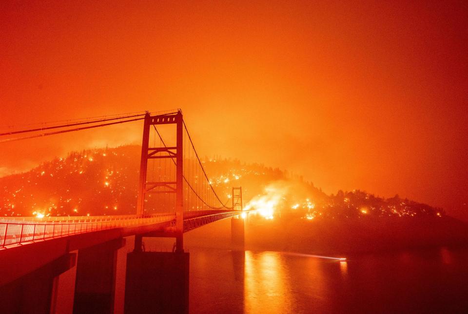 The Bidwell Bar Bridge is surrounded by fire in Lake Oroville during the Bear fire in Oroville, California on September 9, 2020. / Credit: JOSH EDELSON/AFP via Getty Images