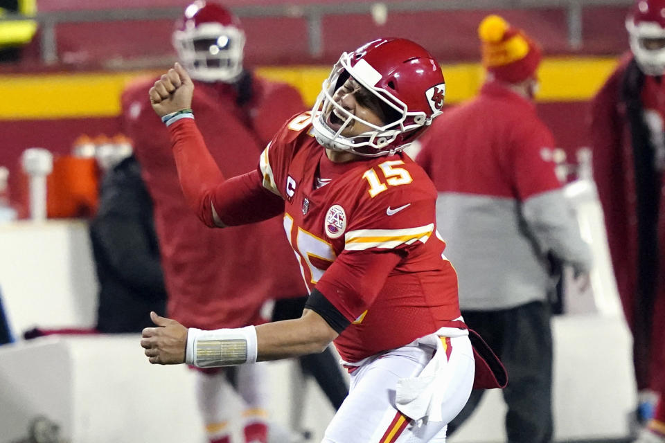 FILE - In this Sunday, Jan. 24, 2021, file photo, Kansas City Chiefs quarterback Patrick Mahomes celebrates after throwing a 5-yard touchdown pass to tight end Travis Kelce during the second half of the AFC championship NFL football game against the Buffalo Bills in Kansas City, Mo. The Super Bowl matchup features the most accomplished quarterback ever to play the game who is still thriving at age 43 in Brady against the young gun who is rewriting record books at age 25. (AP Photo/Jeff Roberson, File)