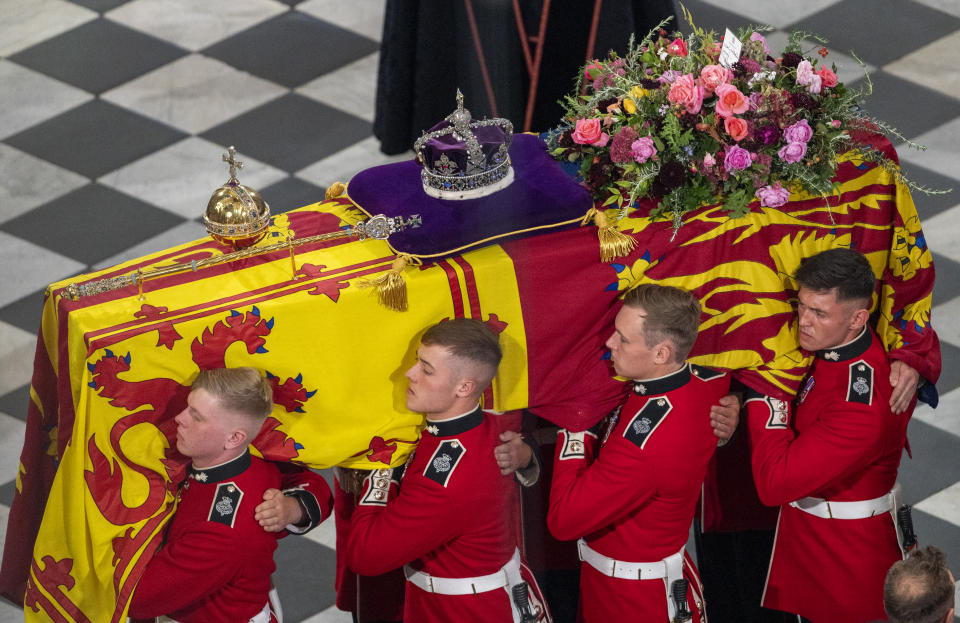 LONDON, ENGLAND - SEPTEMBER 19:The pall bearers lead the coffin away during the State Funeral of Queen Elizabeth II at Westminster Abbey on September 19, 2022 in London, England.  Elizabeth Alexandra Mary Windsor was born in Bruton Street, Mayfair, London on 21 April 1926. She married Prince Philip in 1947 and ascended the throne of the United Kingdom and Commonwealth on 6 February 1952 after the death of her Father, King George VI. Queen Elizabeth II died at Balmoral Castle in Scotland on September 8, 2022, and is succeeded by her eldest son, King Charles III. (Photo by - Mark Large - WPA Pool/Getty Images)