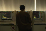 An investor monitors stock prices at a brokerage in Beijing on Thursday, Dec. 12, 2019. Asian shares are mixed after a wobbly day on Wall Street following the Federal Reserve announcement that it would leave interest rates unchanged. Japan's benchmark Nikkei 225, South Korea's Kospi and Hong Kong's Hang Seng rose in early Thursday trading. (AP Photo/Ng Han Guan)