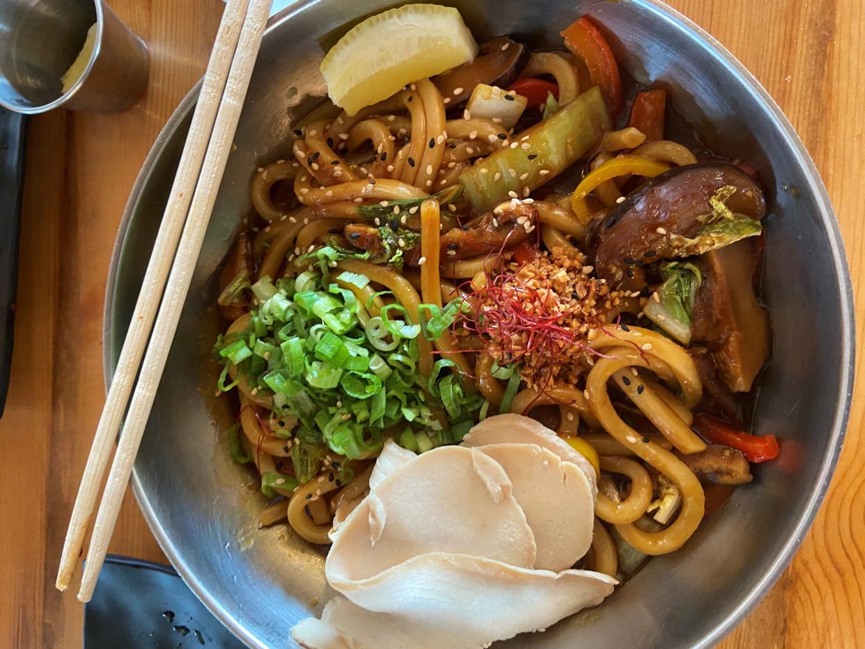 Charshu Chicken Yaki Udon features pan-fried udon noodles with an array of vegetables.