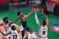 Boston Celtics forward Jayson Tatum, center, drives to the basket against the Chicago Bulls defense during the first half of an NBA basketball game, Monday, April 19, 2021, in Boston. (AP Photo/Charles Krupa)