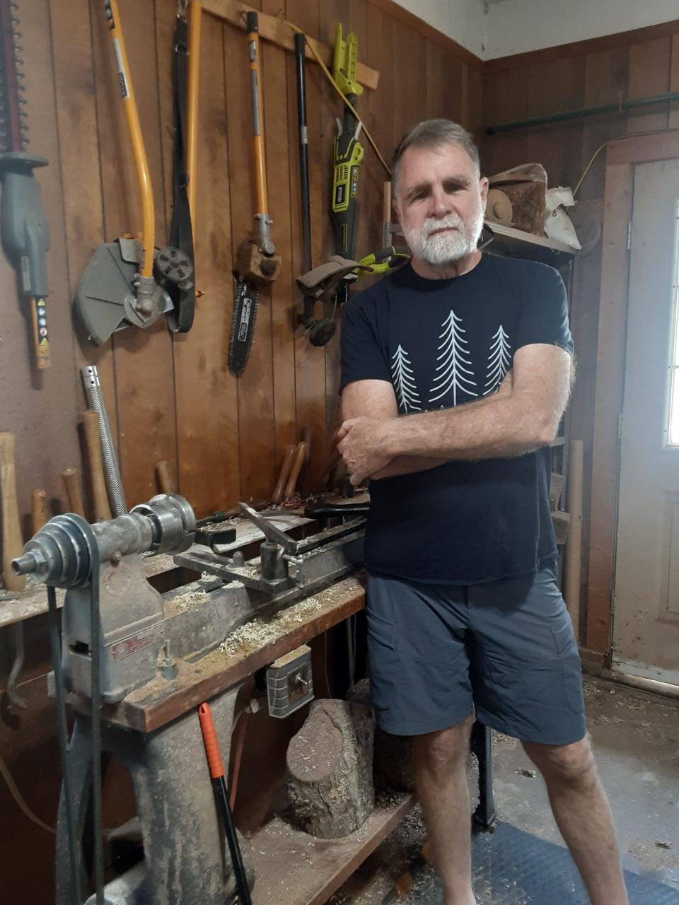 Stephen Holmes in his home workshop with his main wood carving tool, a wood lathe.