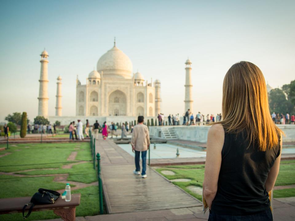 A woman staring out at the Taj Mahal.
