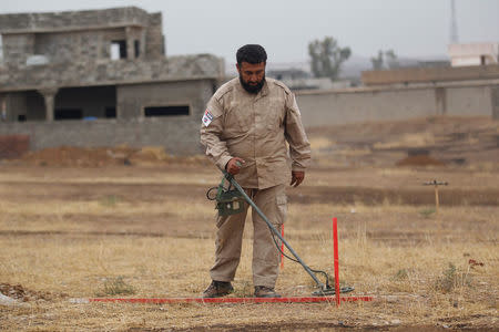 A member of a demining team searches for landmines in Khazer, Iraq December 1, 2016. Picture taken December 1, 2016. REUTERS/Khalid al Mousily