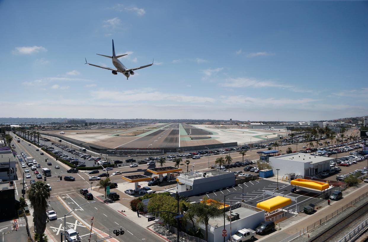 A plane lands at San Diego International Airport.