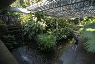 A visitor walks in the garden during a guided tour of Roberto Burle Marx’s former home, which was elected today as a World Heritage Site by the United Nations Educational, Scientific and Cultural Organization, UNESCO, in Rio de Janeiro, Brazil, Tuesday, July 27, 2021. The site features more than 3,500 species of plants native to Rio and is considered a laboratory for botanical and landscape experimentation. (AP Photo/Bruna Prado)