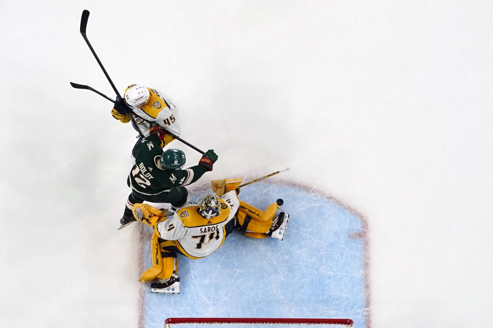 Nashville Predators goaltender Juuse Saros (74) and defenseman Alexandre Carrier (45) defend the goal against Minnesota Wild left wing Matt Boldy (12) during the third period of an NHL hockey game Thursday, Jan. 25, 2024, in St. Paul, Minn. (AP Photo/Abbie Parr)